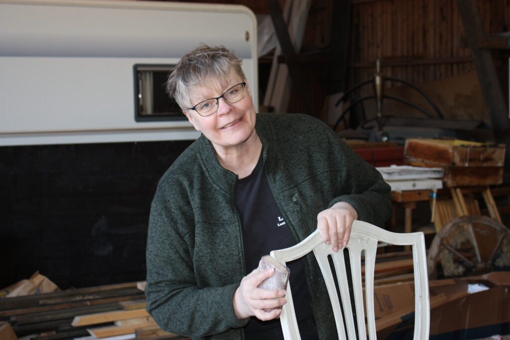 Ann-Carina arbetar med renovering av en vit stol